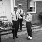 Chief J. Russell Thompson watches Deputy Chief Joe Armstrong present the ward for Best Musical Unit to a Representitive of the Colonel John Chester Fife and Drum Corp.
