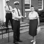 Chief J. Russell Thompson watches Deputy Chief Joe Armstrong present the ward for Best Appearing Auxiliary to a representitive of the Bolton unit